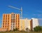 Construction of multistory residential building. Holes for windows and balconies on the facade of unfinished condo. New