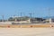 Construction of a new airport terminal building, view of cranes machinery and aircraft parked around. Transport hub reconstruction