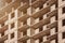 Construction of a new brick house with balconies. Closeup of a wall with sunlight