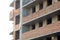 Construction of a new multi-storey building. A man worker puts a brick in the construction. Brick masonry of the balcony