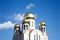 Construction of a new temple with gold domes against blue sky