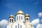 Construction of a new temple with gold domes against blue sky