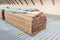 Construction place with wooden long yellow stacked planks