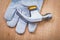 Construction protective glove and claw hammer on wooden board