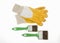 Construction protective gloves in yellow with two green brushes on a white background
