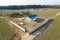Construction and repair of country houses. New cottage with double-glazed windows on the plot. Aerial view from a drone to a