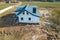 Construction and repair of country houses. New cottage with double-glazed windows on the plot. Aerial view from a drone to a