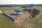 Construction and repair of country houses. New cottage with double-glazed windows on the plot. Aerial view from a drone to a