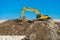 Construction of the road. Excavator modified photo levels the mound of sand.