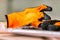 Construction rubberized gloves at a construction site. Orange protective rubber gloves for construction and operation with caustic