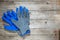 Construction rubberized gloves on a wooden background. Blue protective rubber gloves for construction and operation with caustic s