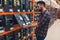 construction shop shopper next to rack with doorknobs and locks