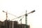 Construction site background. Hoisting cranes and new multi-storey buildings. Copy space for text. ndustrial background.