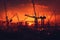 Construction site bathed in the warm glow of a mesmerizing sunset. Witness the colossal presence of giant construction cranes