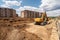 construction site with bulldozer digging and moving dirt