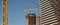 Construction site in the city. Cranes and buildings against the sky