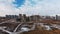 Construction site. Construction of modern high-rise buildings. Work construction cranes. Snow covered earth. Aerial photography