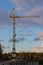 Construction site with crane, dusk evening dramatic sky