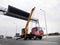 Construction site crane is lifting a led signboard for advertisement