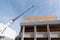 Construction site crane is lifting a precast wooden wall panel