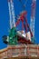 Construction site with cranes, blue sky on the background