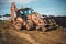 Construction site details with backhoe wheel loader moving soil and earth