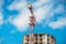 Construction site of multistore building with tower cranes and blue sky. Perspective view