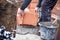 Construction site of new house, worker building the brick wall with trowel, cement and mortar