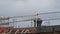 Construction site one worker with hat roofer working on top of building