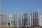 Construction site. Reinforced concrete frames of multi-storey buildings and construction cranes. The final stage of construction.