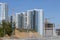 Construction site. Reinforced concrete frames of multi-storey buildings and construction cranes. The final stage of construction.