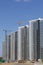 Construction site. Reinforced concrete frames of multi-storey buildings and construction cranes. The final stage of construction.