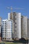 Construction site. Reinforced concrete frames of multi-storey buildings and construction cranes. The final stage of construction.