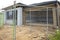 The construction site of a residential suburban house with a temporary fence.