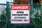 Construction site safety signage with text: Danger, open excavation, authorized personnel only.