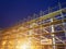 Construction site with scaffold tower and warning label building with dusk background,scaffolding for construction factory