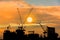 Construction site silhouette on tower building rooftop twilight