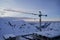 Construction site of ski resort hotel chalet framework and crane with snowy mountain ridge on winter sunrise on