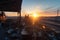 construction site with view of the sunrise, machines and debris in the foreground