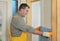 Construction site, worker installing gypsum board