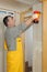 Construction site, worker installing gypsum board