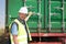 construction site worker opening the back of a container on a truck