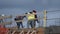 Construction site workers with hat roofers working on top of building