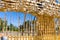 Construction team, new building construction with roof carpentry works on roof at height workers nailing wood beams