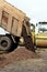 Construction truck unloads ground to the construction site and road widening