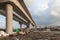 Construction of an urban multi-level road junction. Concrete overpass on high supports. The process of building roads