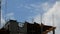 Construction work at the construction site. Builders mount the formwork. The blue sky clouds