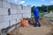 Construction work on the construction site, soil compaction with a vibrating plate, manual equipment