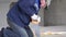 Construction work - a man sawing sawn wooden floor boards