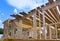 Construction work in progress viewing an unfinished house with wooden framing beams